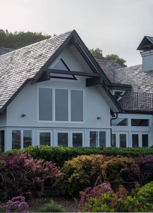 A beautiful luxury villa surrounded by a vibrant garden showcasing exquisite design and elegance.