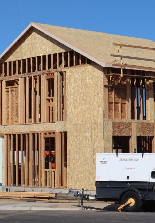 A new house under construction in Elk Grove, showing wooden framing and building materials.