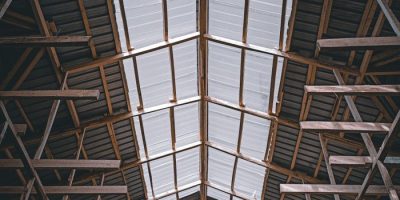 Viewing the intricate wooden framework supporting a warehouse ceiling.
