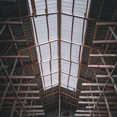 Viewing the intricate wooden framework supporting a warehouse ceiling.
